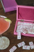 La table de cocktail du salon offre une zone de mise en scène spacieuse pour une boîte de dominos rose, des piles de livres et d'autres objets préférés.