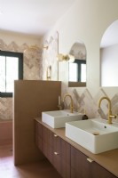 Lavabos doubles avec robinets dorés dans une salle de bains de style rétro